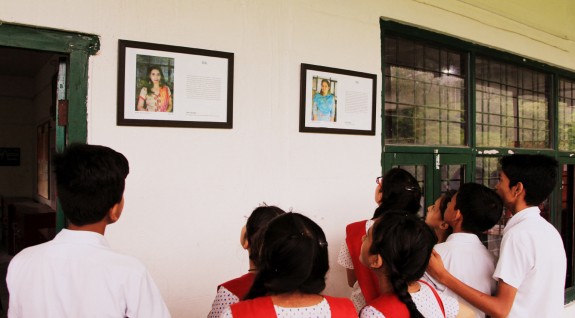 Students look at teachers’ life lessons displayed in a “wisdom corridor” in their school.