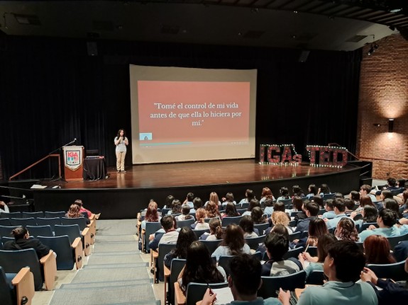 A student performs her final talk at the end of year event